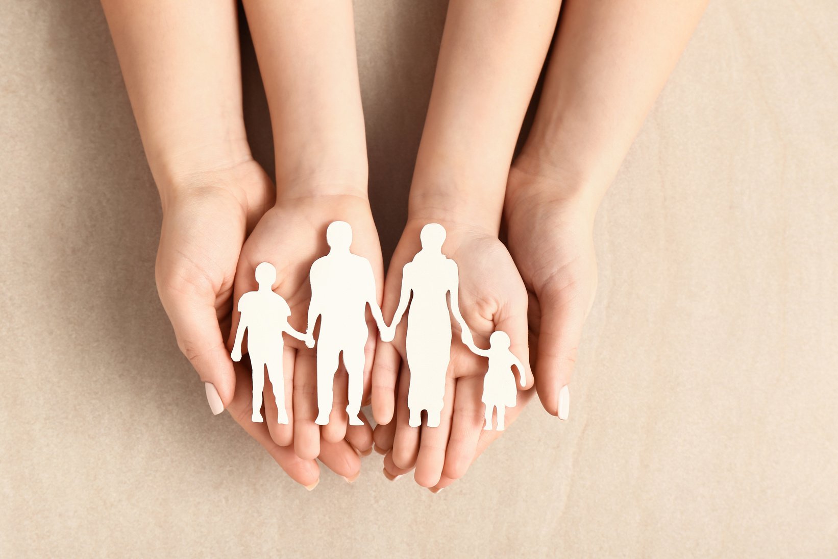 Hands of Woman and Child with Figure of Family on Light Background. Adoption Concept